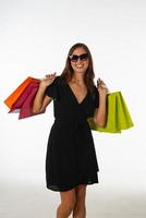 Young beautiful woman holding shopping bag on isolated white background photo