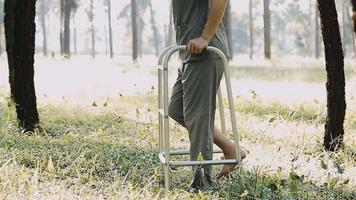 young asian physical therapist working with senior woman on walking video