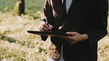 Business people using tablets And using his finger to touch the screen With a business graph showing up in a virtual screen.New startup ideas and business growth concept. video