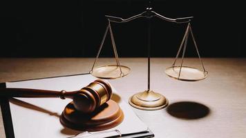 Justice and law concept.Male judge in a courtroom with the gavel, working with, computer and docking keyboard, eyeglasses, on table in morning light video