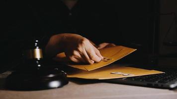 Business and lawyers discussing contract papers with brass scale on desk in office. Law, legal services, advice, justice and law video