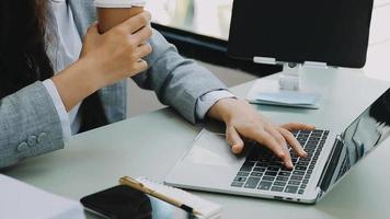 Businessman working with smart phone and laptop and digital tablet computer in office with digital marketing video