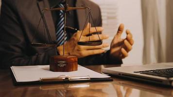 Justice and law concept.Male judge in a courtroom with the gavel, working with, computer and docking keyboard, eyeglasses, on table in morning light video