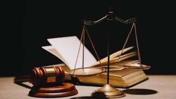 Justice and law concept.Male judge in a courtroom with the gavel, working with, computer and docking keyboard, eyeglasses, on table in morning light video