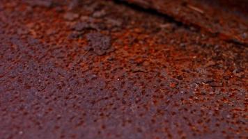 Rusty painted metal surface. Macro view of corrosion in iron metal, texture background. Smooth slow motion