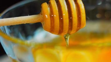 The chef mixes the ingredients for the honey and mustard sauce with a golden spoon video