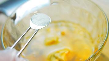 The cook pours honey into the transparent bowl. Use a wooden spoon for honey video