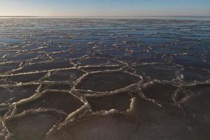 Baltic Sea Coast With Pebbles And Ice at Sunset photo