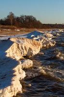 Baltic Sea Coast With Pebbles And Ice at Sunset photo