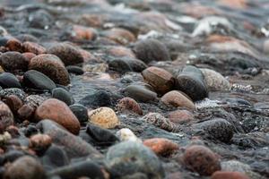 Baltic Sea Coast With Pebbles And Ice at Sunset photo