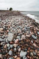 Baltic Sea Coast With Pebbles And Ice at Sunset photo