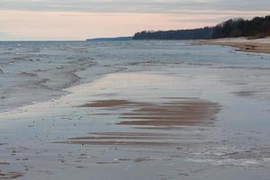 Baltic Sea Coast With Pebbles And Ice at Sunset photo