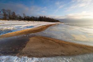 Baltic Sea Coast With Pebbles And Ice at Sunset photo