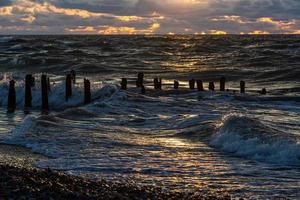 Baltic Sea Coast With Pebbles And Ice at Sunset photo