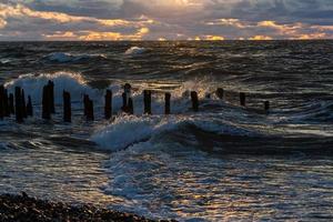 Baltic Sea Coast With Pebbles And Ice at Sunset photo