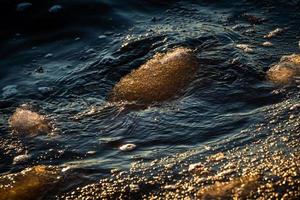 Baltic Sea Coast With Pebbles And Ice at Sunset photo