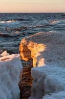Baltic Sea Coast With Pebbles And Ice at Sunset photo