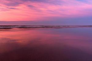 Baltic Sea Coast With Pebbles And Ice at Sunset photo