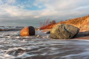 Baltic Sea Coast With Pebbles And Ice at Sunset photo