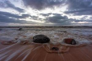 Baltic Sea Coast With Pebbles And Ice at Sunset photo