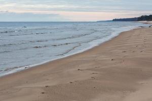 Baltic Sea Coast With Pebbles And Ice at Sunset photo