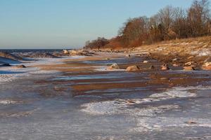 Baltic Sea Coast With Pebbles And Ice at Sunset photo