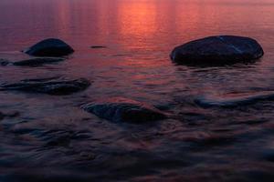 piedras en la costa del mar Báltico al atardecer foto