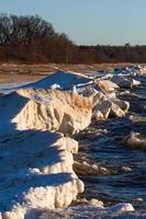 Baltic Sea Coast With Pebbles And Ice at Sunset photo