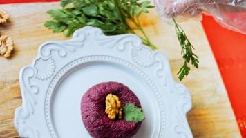 Pkhali traditional Georgian food. Beetroot is used for the purple color. Walnut is used for decoration video