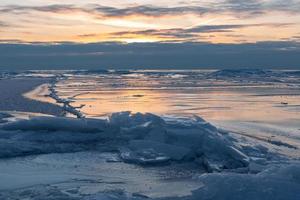 Baltic Sea Coast in Winter With Ice at Sunset photo