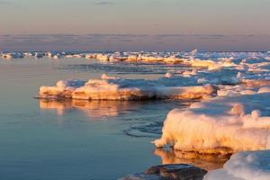 Baltic Sea Coast in Winter With Ice at Sunset photo