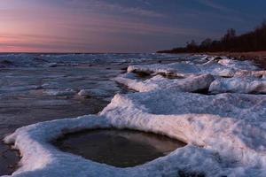 Baltic Sea Coast in Winter With Ice at Sunset photo