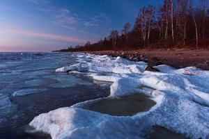 Baltic Sea Coast in Winter With Ice at Sunset photo