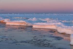 Baltic Sea Coast in Winter With Ice at Sunset photo