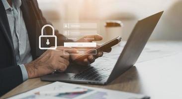 Business man working on mobile phone and laptop. Cybersecurity Global network security technology, business protect personal information. Encryption padlock icon virtual interface. Technology concept. photo