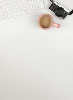 flat lay of computer keyboard, digital camera and a cup of coffee on white background. A4 size photo