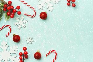 Christmas concept background. Top view of christmas ornaments, caramel canes and snowflakes with space for text photo