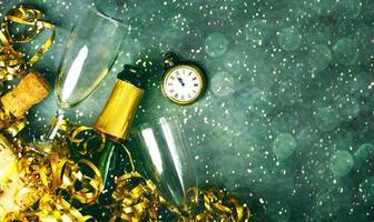 Happy New Year. Top view of champagne bottle,two glasses,golden streamers,antique clock and christmas lights with space for text. New Years Eve celebration concept background photo