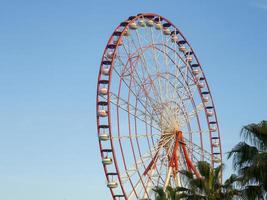 Ferris wheel against the sky. Amusement park on the sea. Rest zone. Ferris wheel. Round car. photo