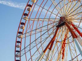 Ferris wheel against the sky. Amusement park by the sea. Rest zone. Round mechanism. Height lovers.