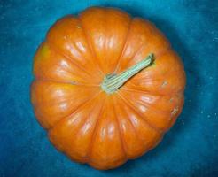 Big pumpkin on a dark background. Vegetables on the table. Preparing for Halloween. photo