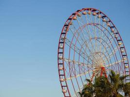 Ferris wheel against the sky. Amusement park on the sea. Rest zone. Ferris wheel.