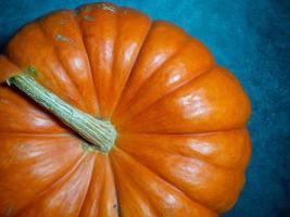 Big pumpkin on a dark background. Vegetables on the table. Preparing for Halloween. photo