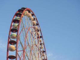 Ferris wheel against the sky. Amusement park on the sea. Rest zone. photo