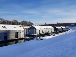 Hotel on boats is called Wotel on the Vistula River in Krakow, Poland. Modern smart home or office technologies. Sunny winter day. photo
