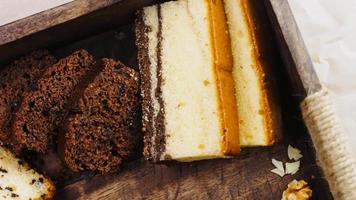 Different kinds of cakes arranged on a wooden tray video