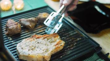 The chef grills pork and beef on the grill video