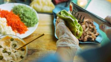 de chef bereidt zich voor taco's. toevoegen gehakt vers salade video