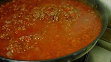 mélanger la viande de dinde et les ingrédients frits dans la poêle. cuisinier chili con carne, cuisine mexicaine video