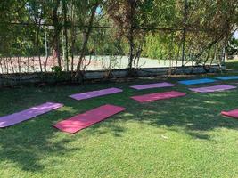 yoga mat on green grass, close up photo, fitness concept photo